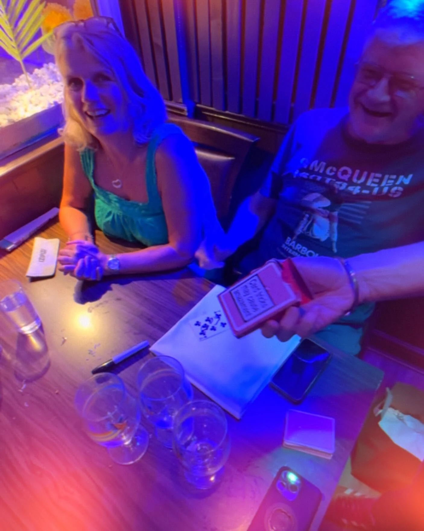 Guests enjoying close-up card magic at their table