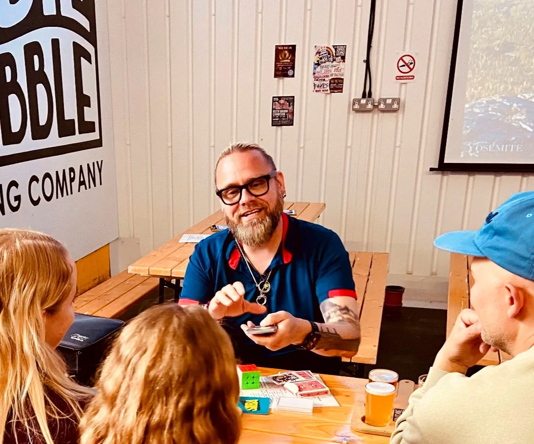Shane Joseph performing close-up magic at a table