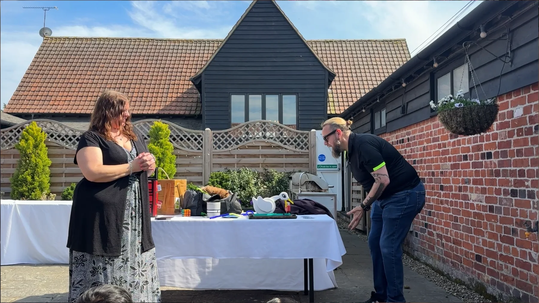 Shane Joseph entertaining a guest during an outdoor private event