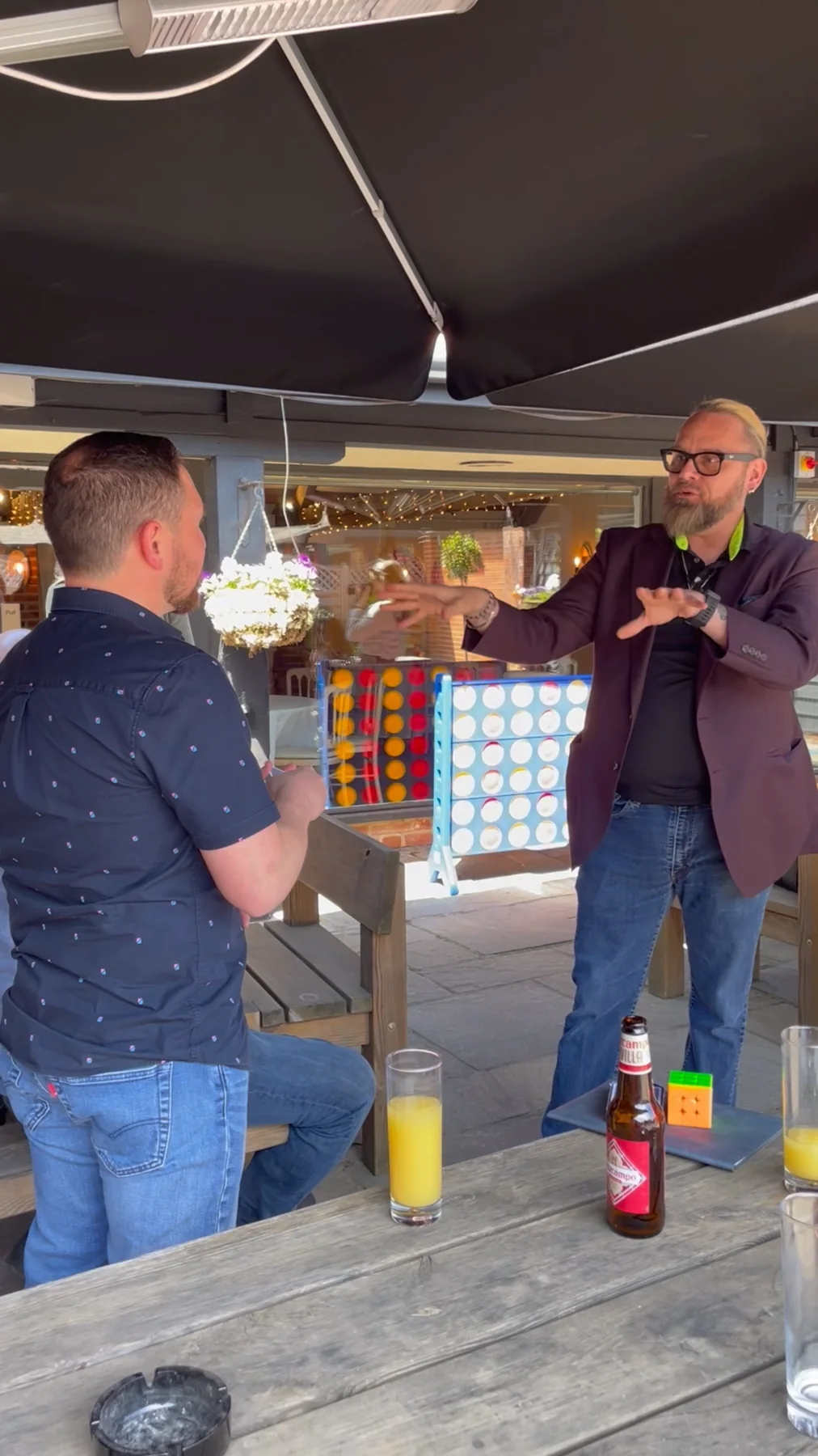 Shane Joseph performing close-up magic for a guest at a private outdoor event